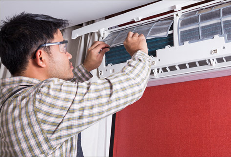 man fixing ductless ac