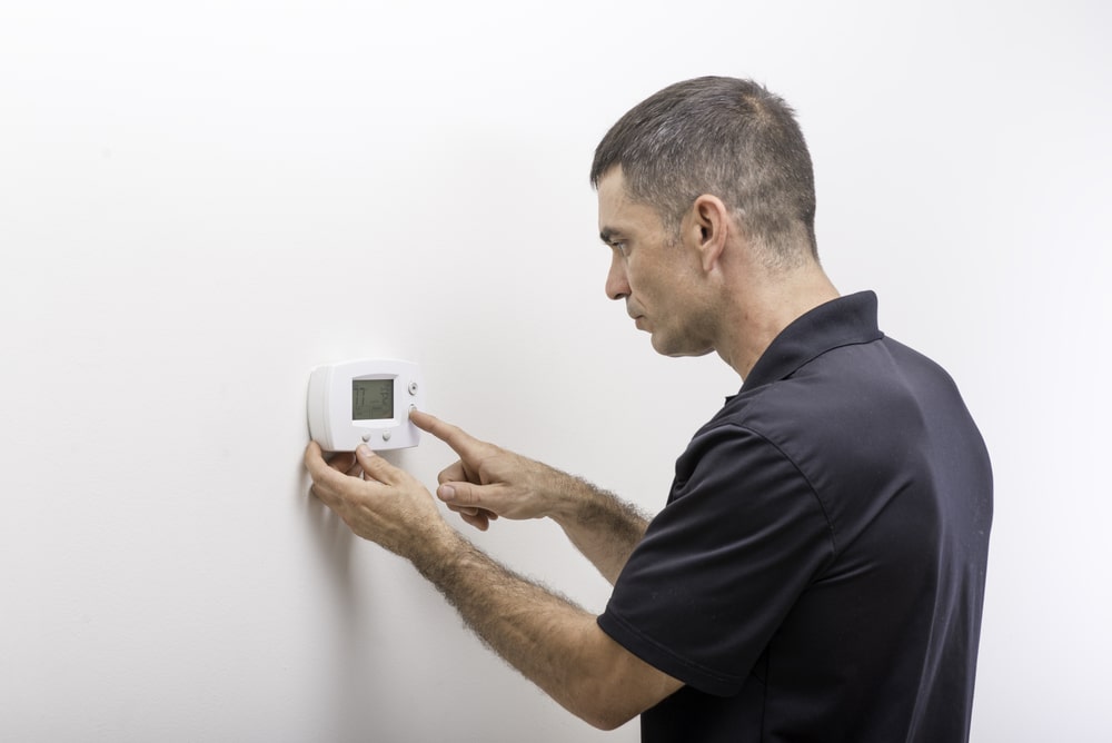 Man troubleshooting AC register issues
