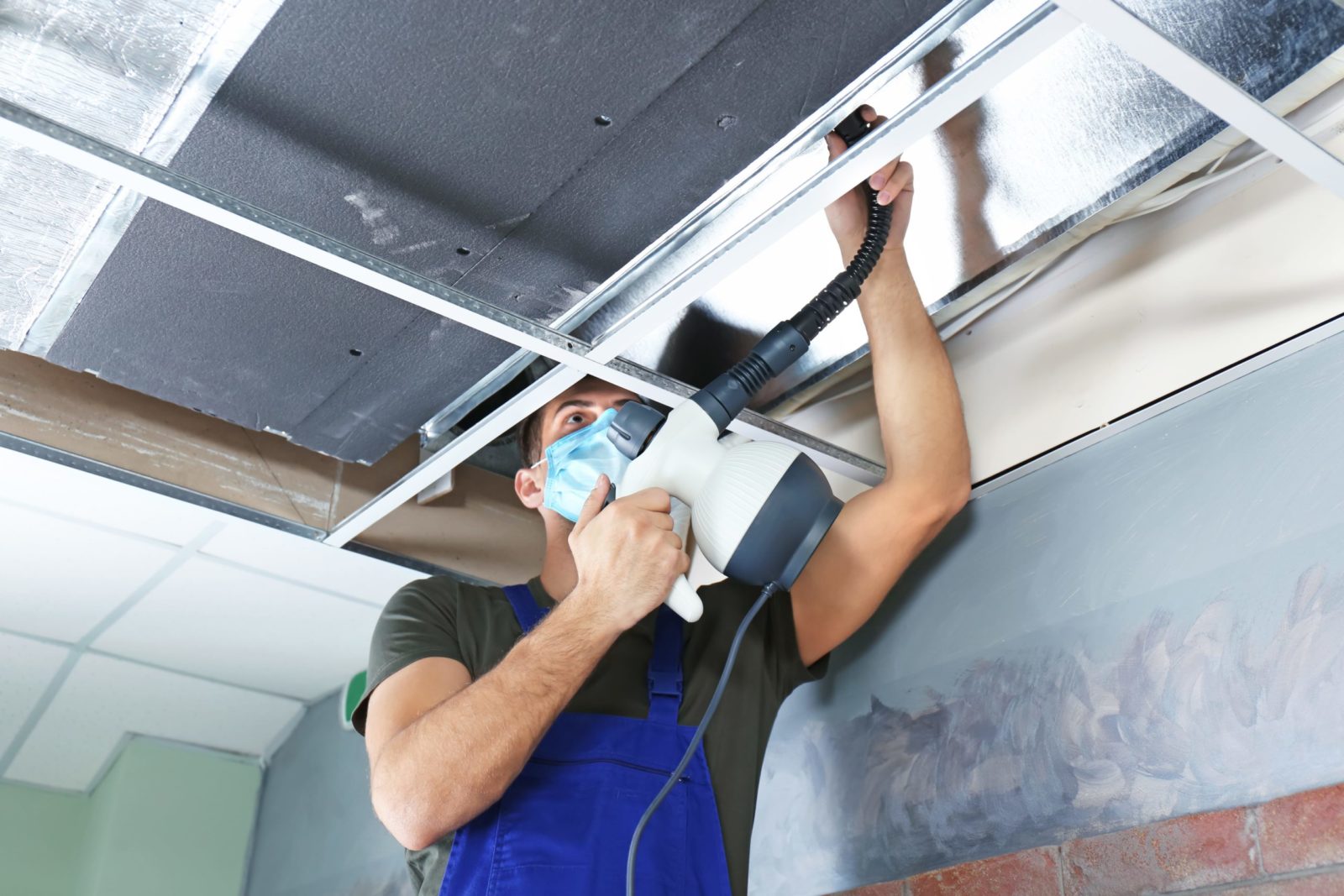 Technician cleaning a home air duct system