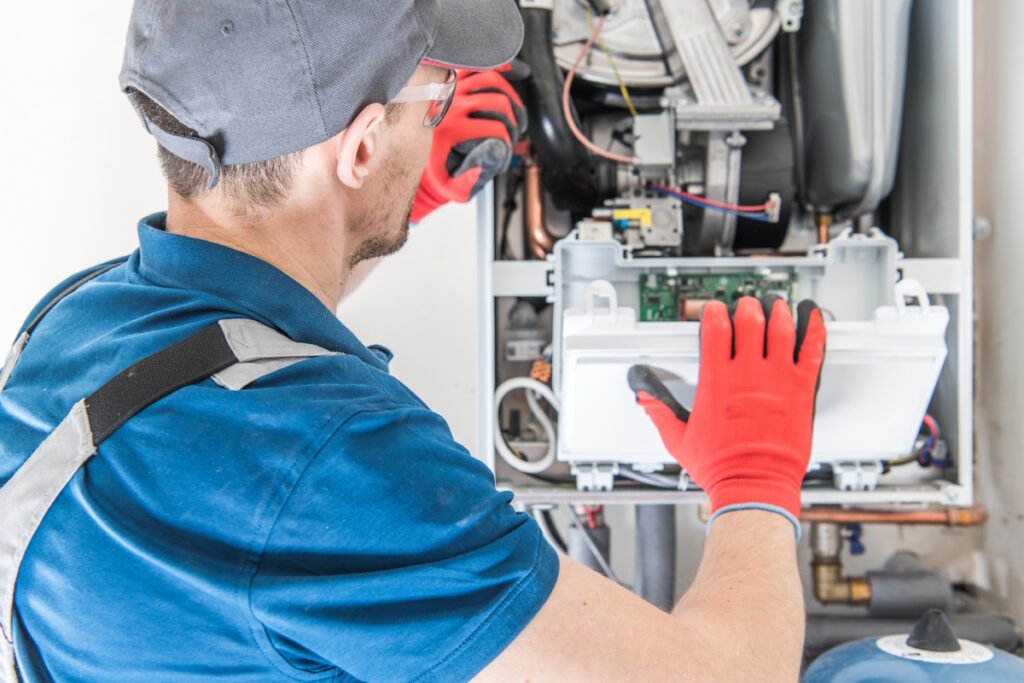 hvac technician checking furnace