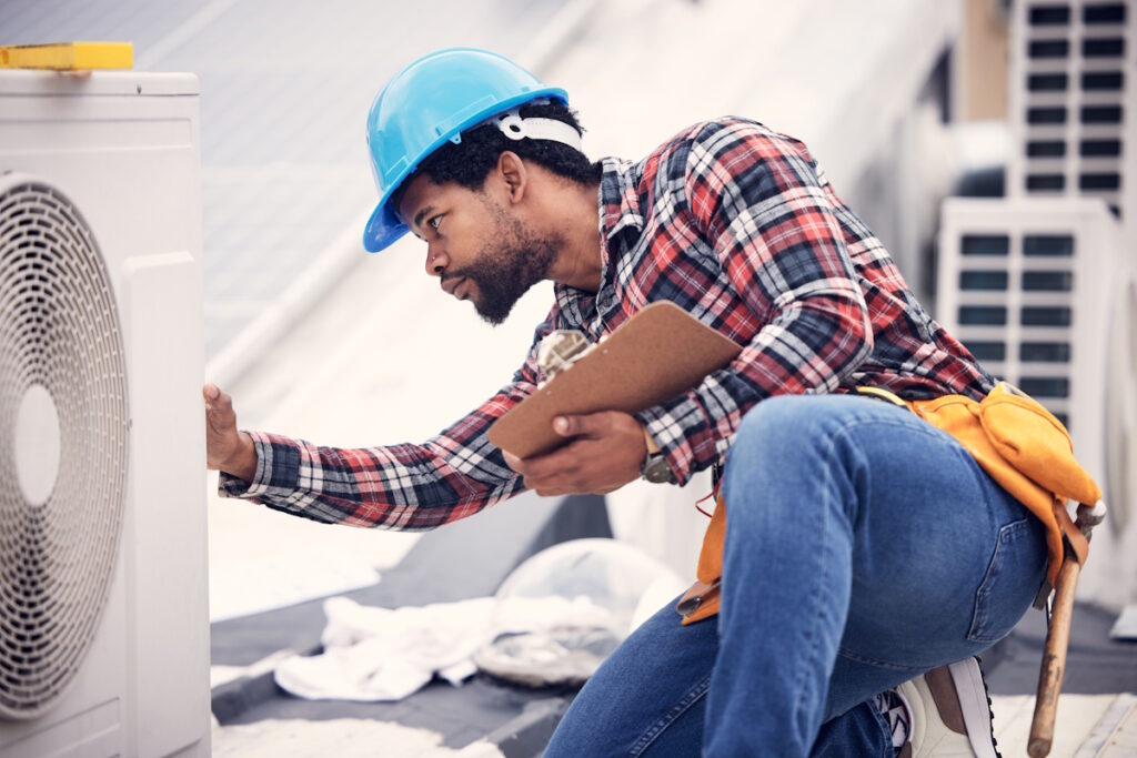 hvac contractor looking at hvac system