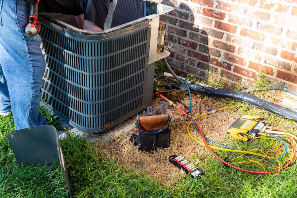 hvac tech working on ac unit