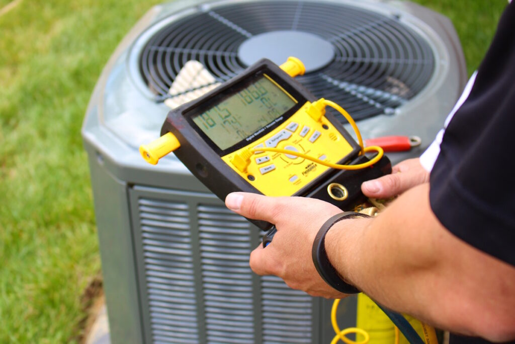 hvac contractor inspecting ac